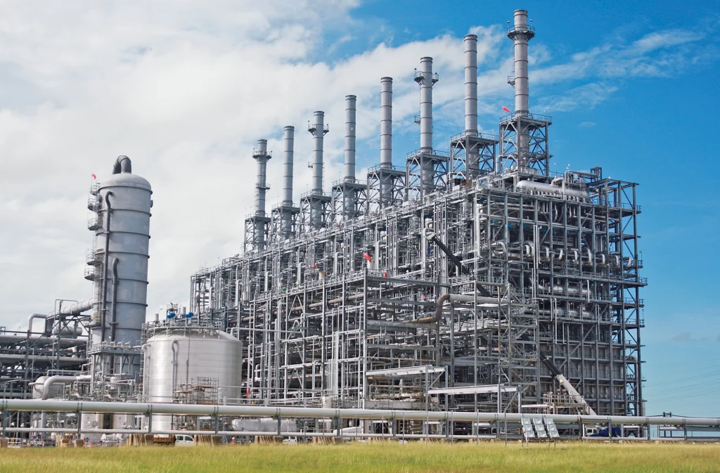 Aerial view of a sprawling petrochemical plant under a clear sky, emphasizing the industrial environment where toluene from naphtha is processed.